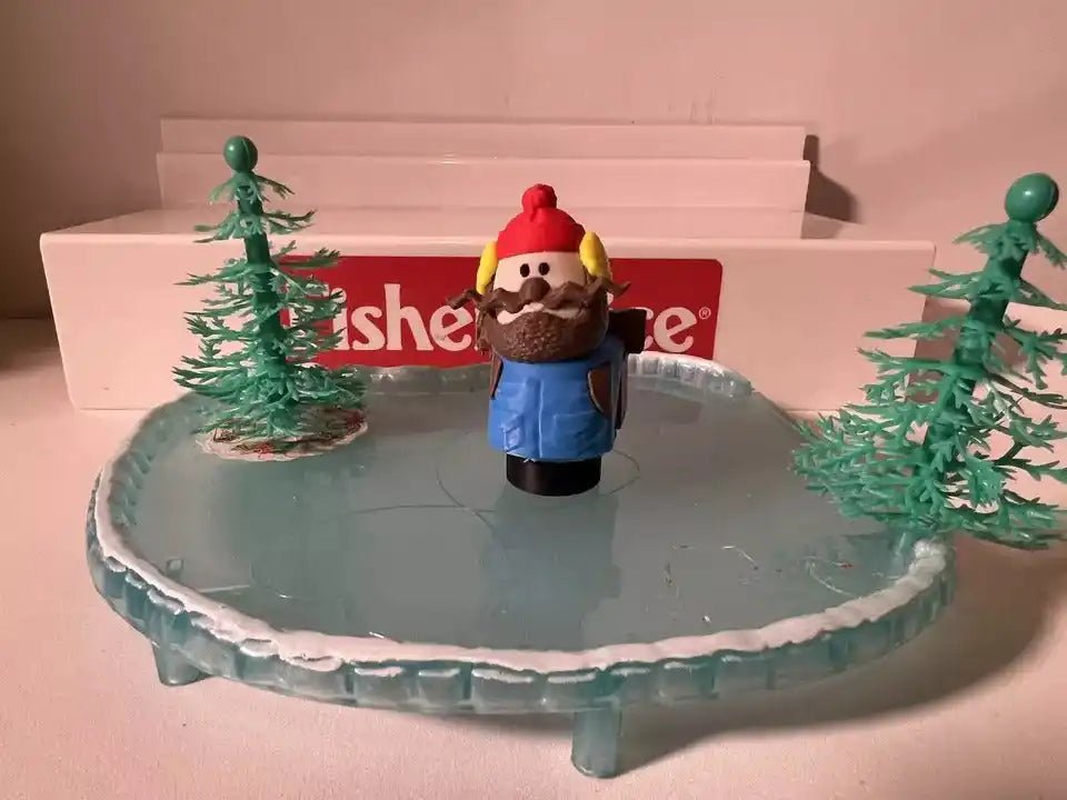Christmas holiday figurine set with nutcracker-style character on round blue icy base and trees