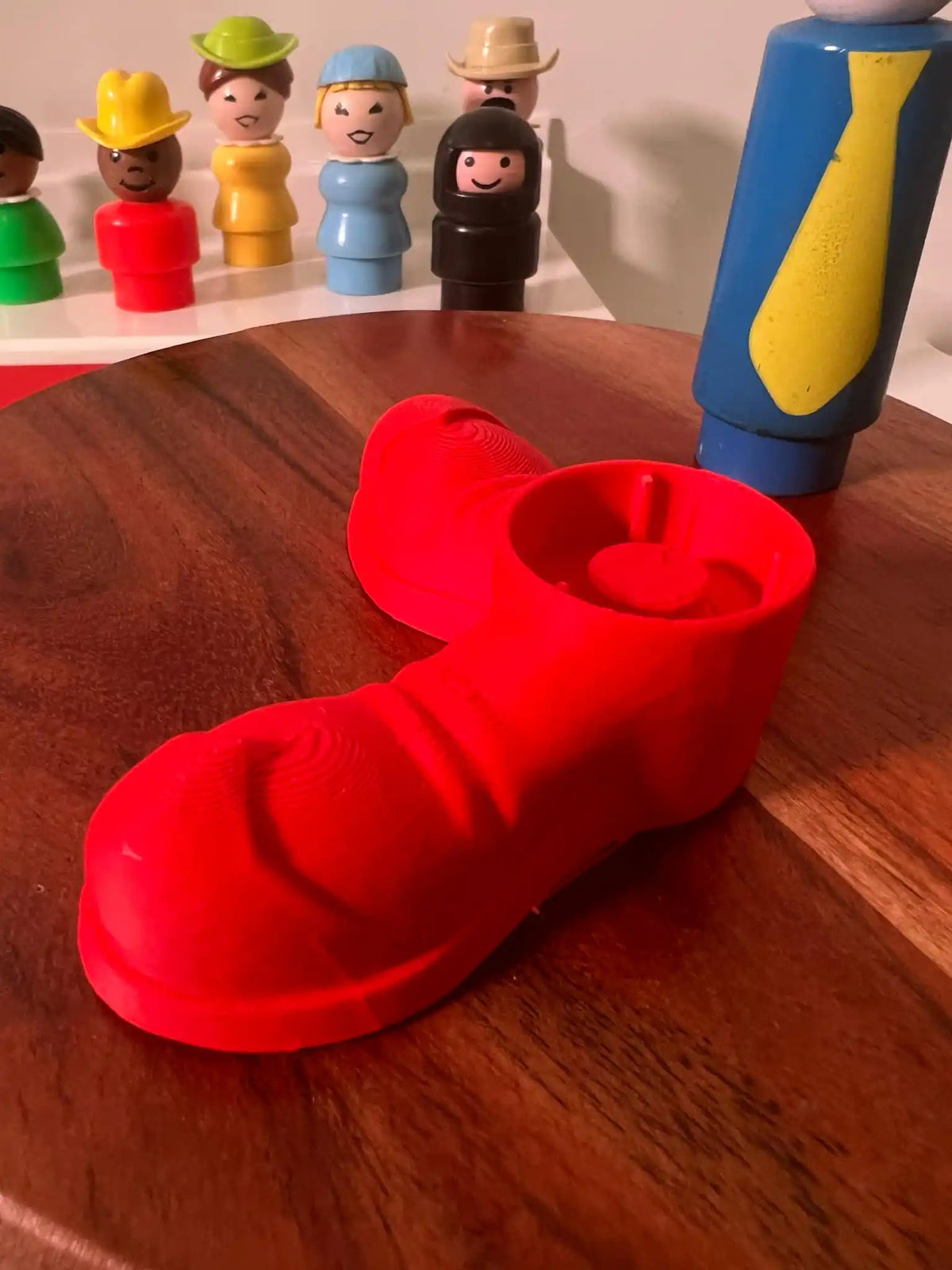 Fisher Price oversized red clown shoes, one shoe prominent