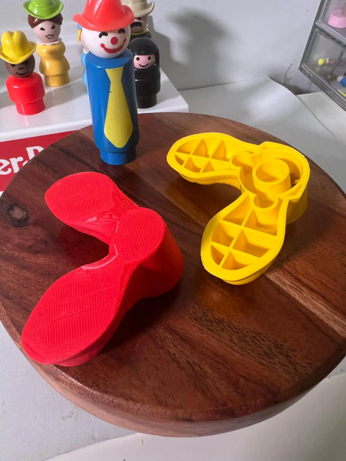 Fisher Price oversized clown shoes, red and yellow on display