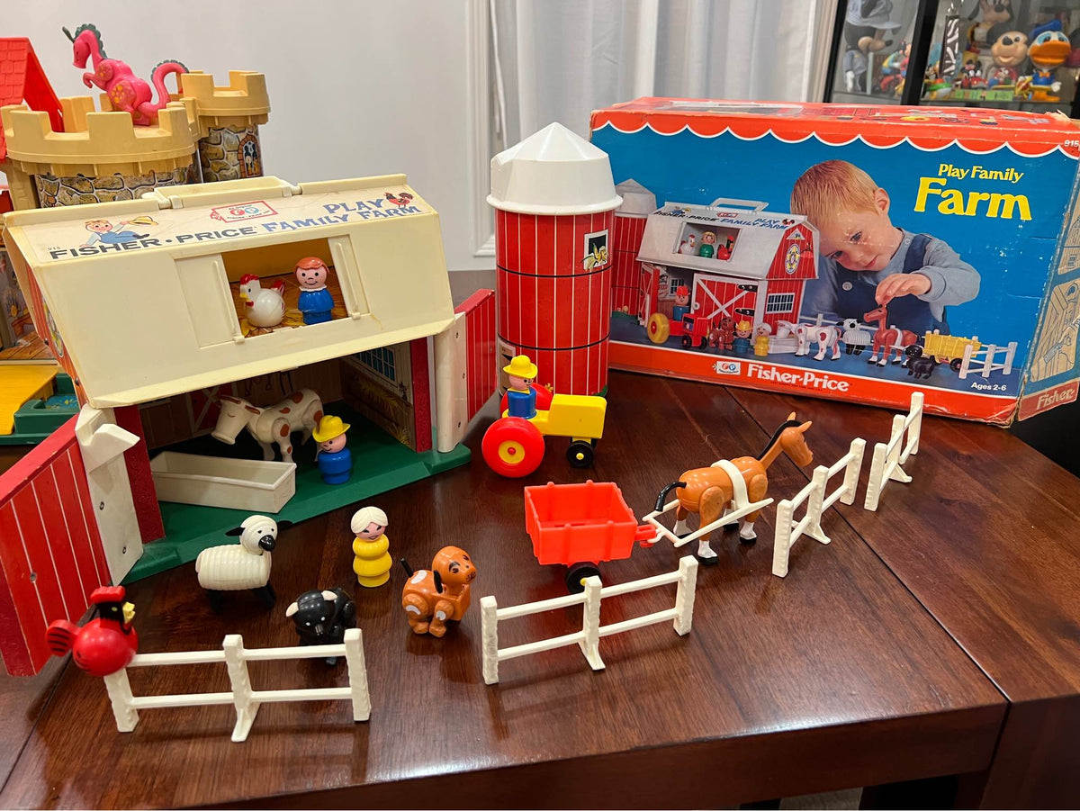 Fisher-Price farm playset pieces with white picket fences, animals, and small vehicles