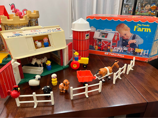 Fisher-Price farm playset pieces with white picket fences, animals, and small vehicles