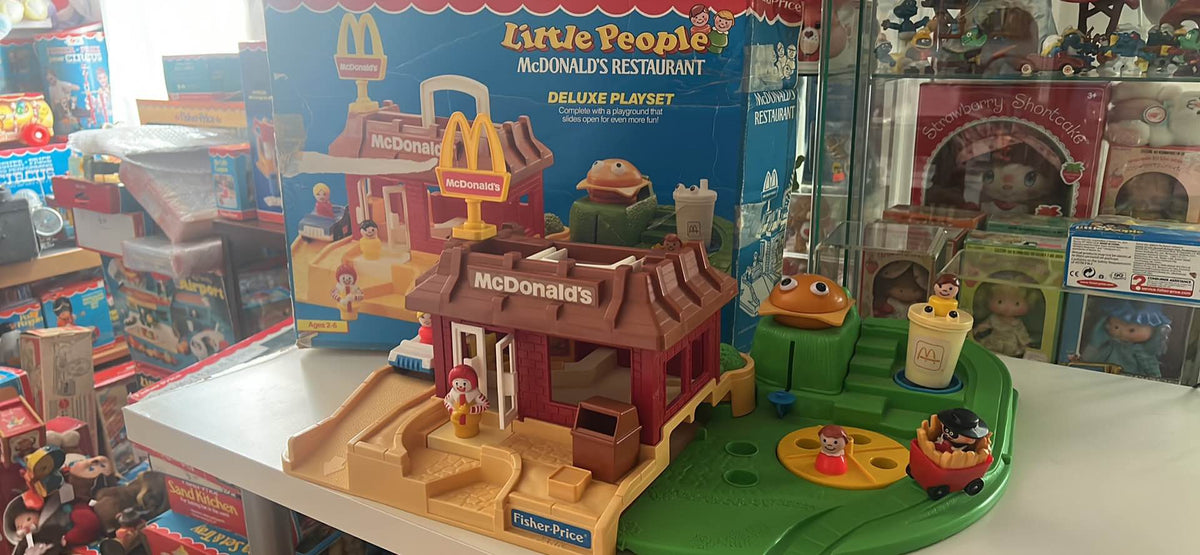 McDonald's restaurant playset with miniature building, people figures, and play accessories
