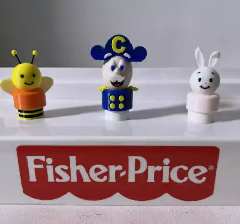 A custom 3D-printed Captain Crunch Little People figure stands with a bee and a bunny on a Fisher-Price display.
