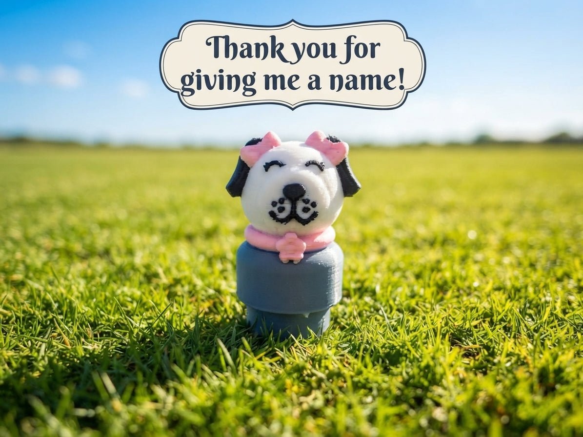 Dog figure toy standing on base, white face, pink ears, navy body, pink collar