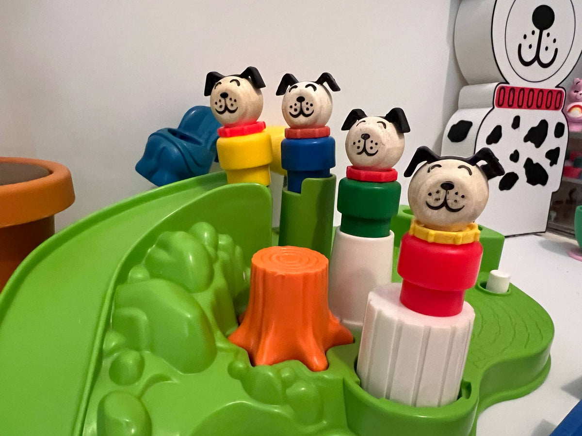 Green dog toy base with stacked dog figures, orange slide, and white blocks