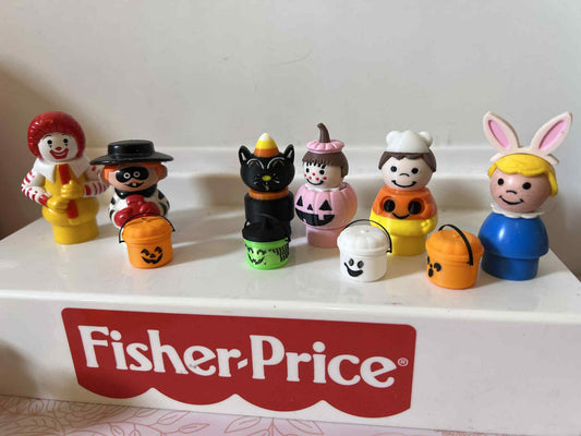 Assorted Halloween character toy buckets with jack-o'-lantern, witch, and ghost faces