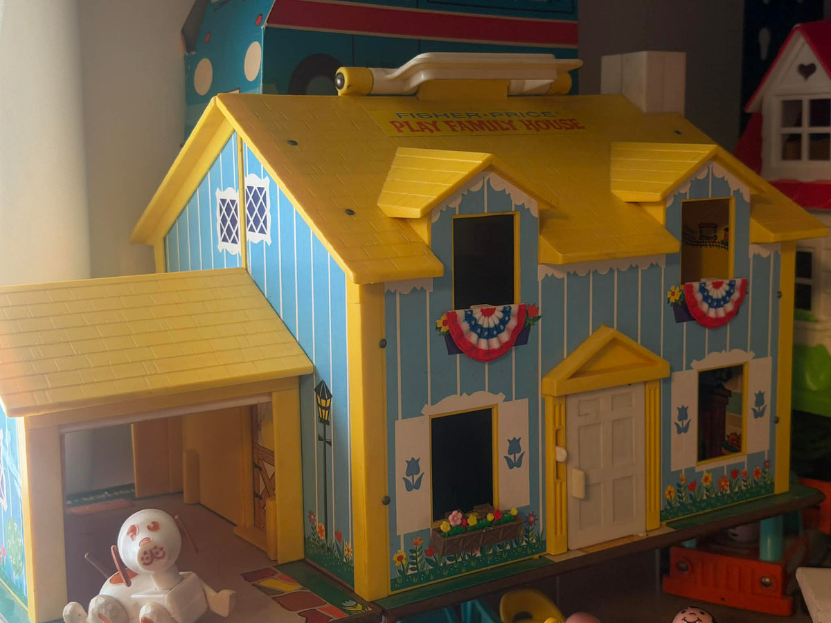 Mini American bunting flags hanging on dollhouse facade windows and porch