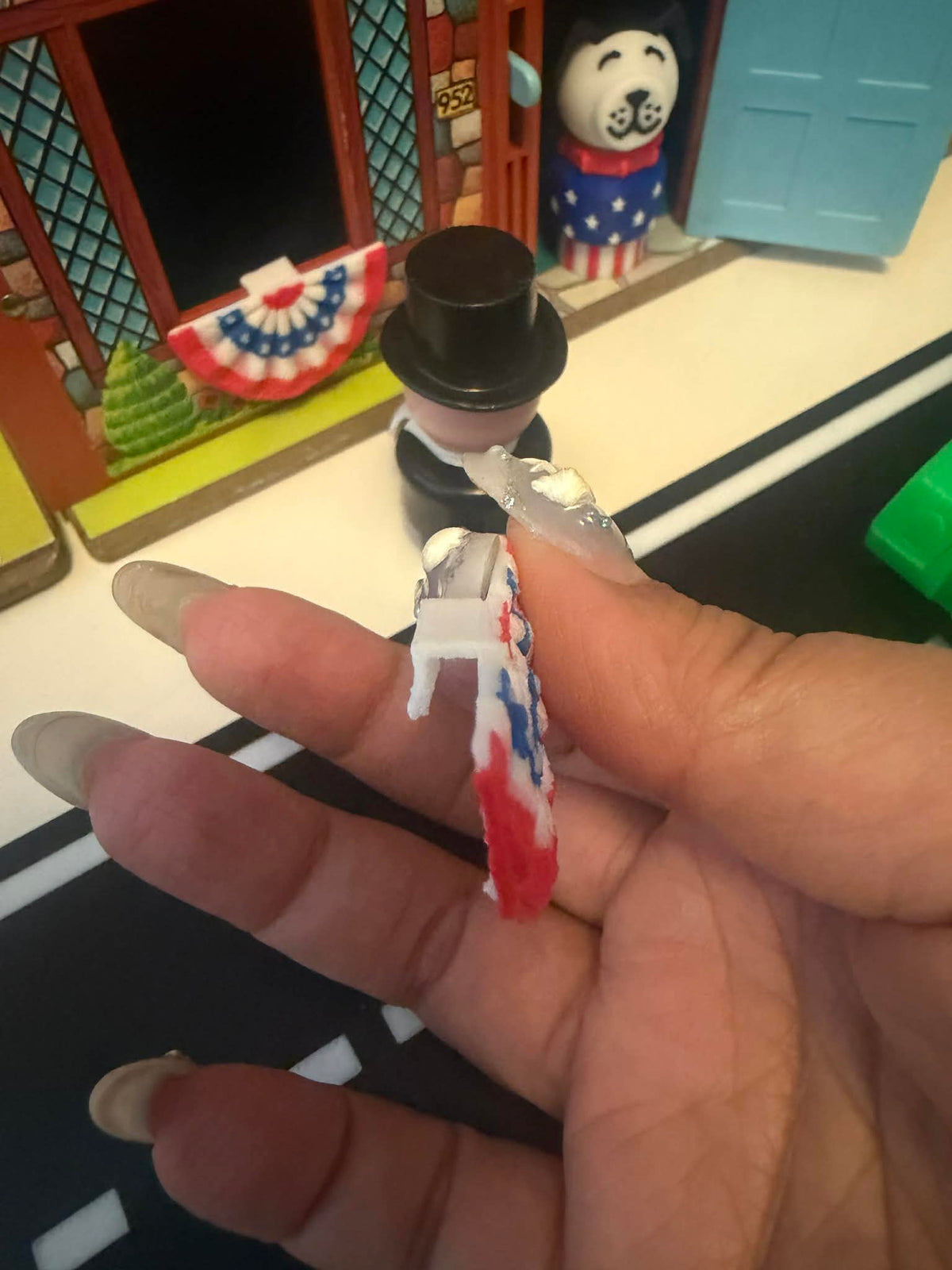Handheld miniature American bunting flag with red border and blue star pattern