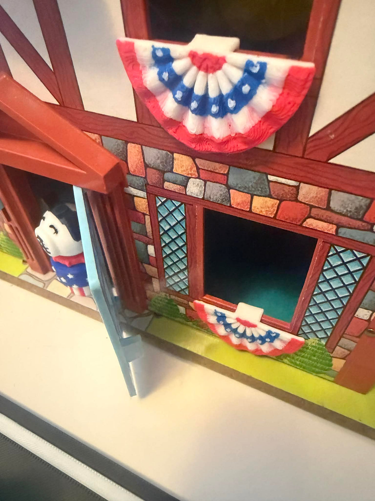 Mini American bunting flag with red, white, and blue scalloped edge for windows