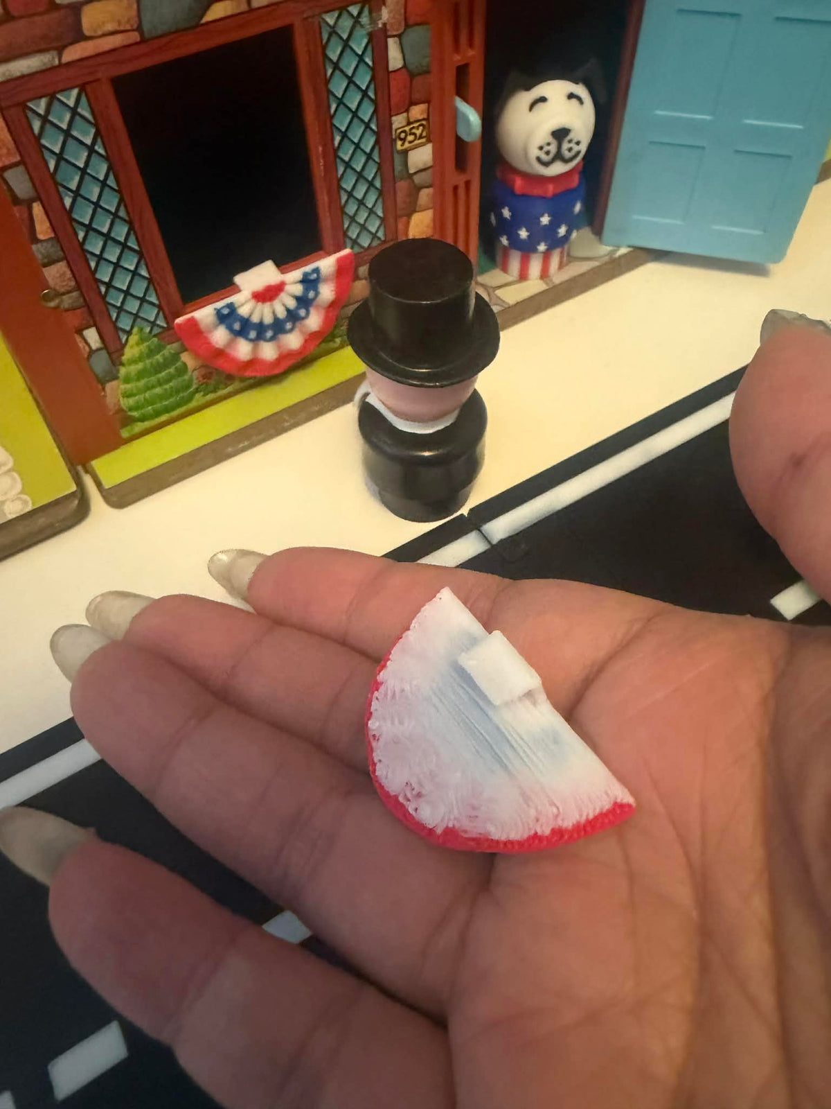 Mini American bunting flag showing red scalloped edge and blue fanburst design