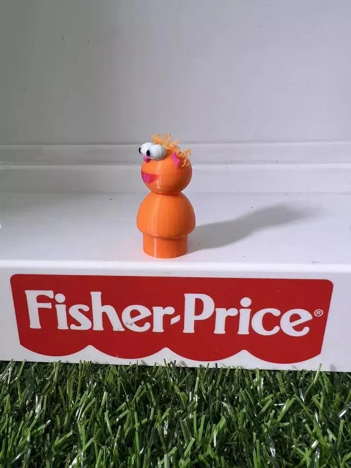 Orange two-part cartoon figure with spiky hair and big eyes, side profile