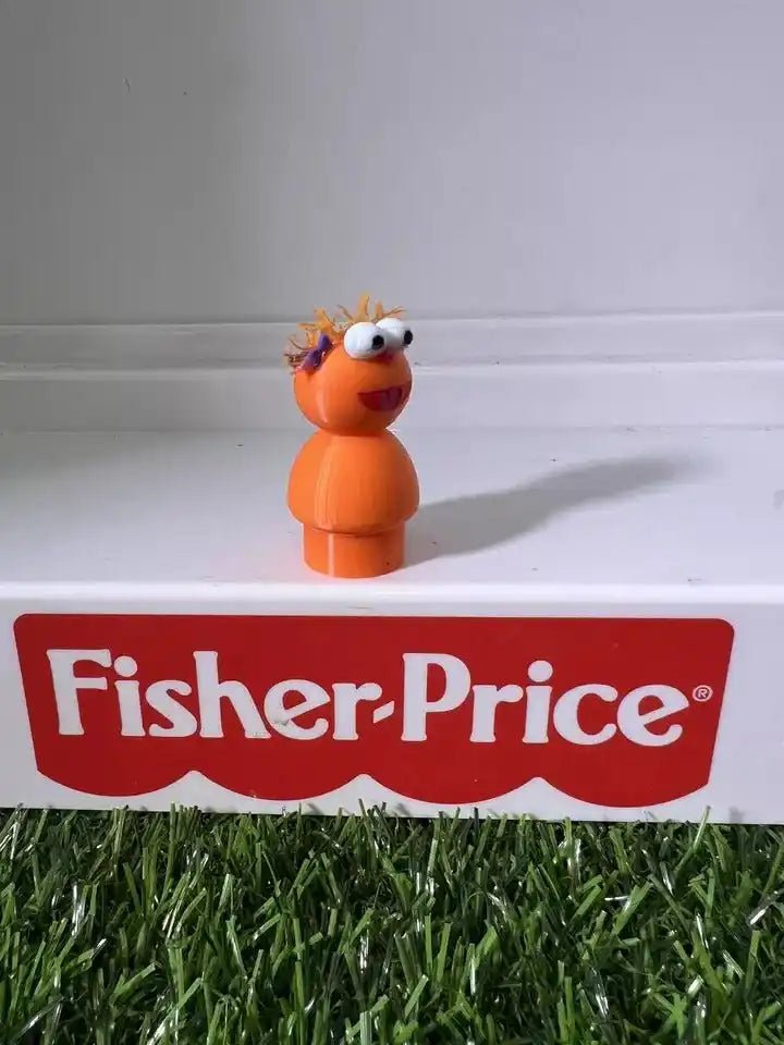 Orange two-part cartoon figure with spiky hair and big eyes, three-quarter side view