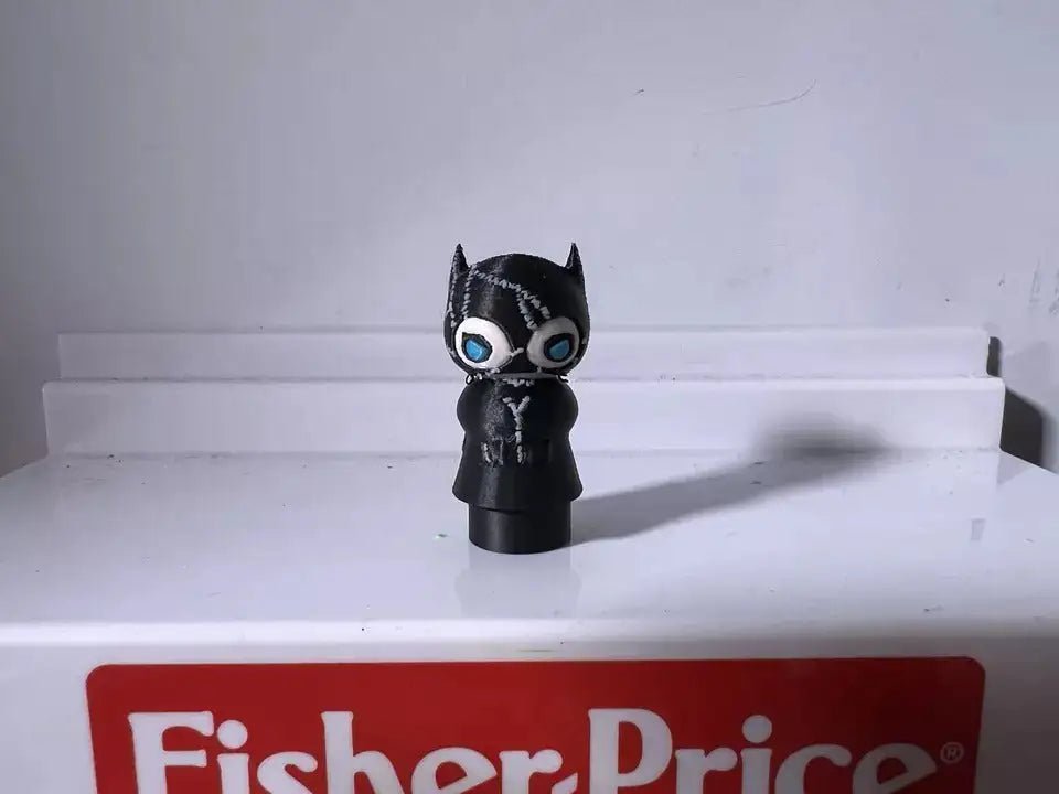 Standing black cat character figurine with blue eyes, pointed ears, and molded details