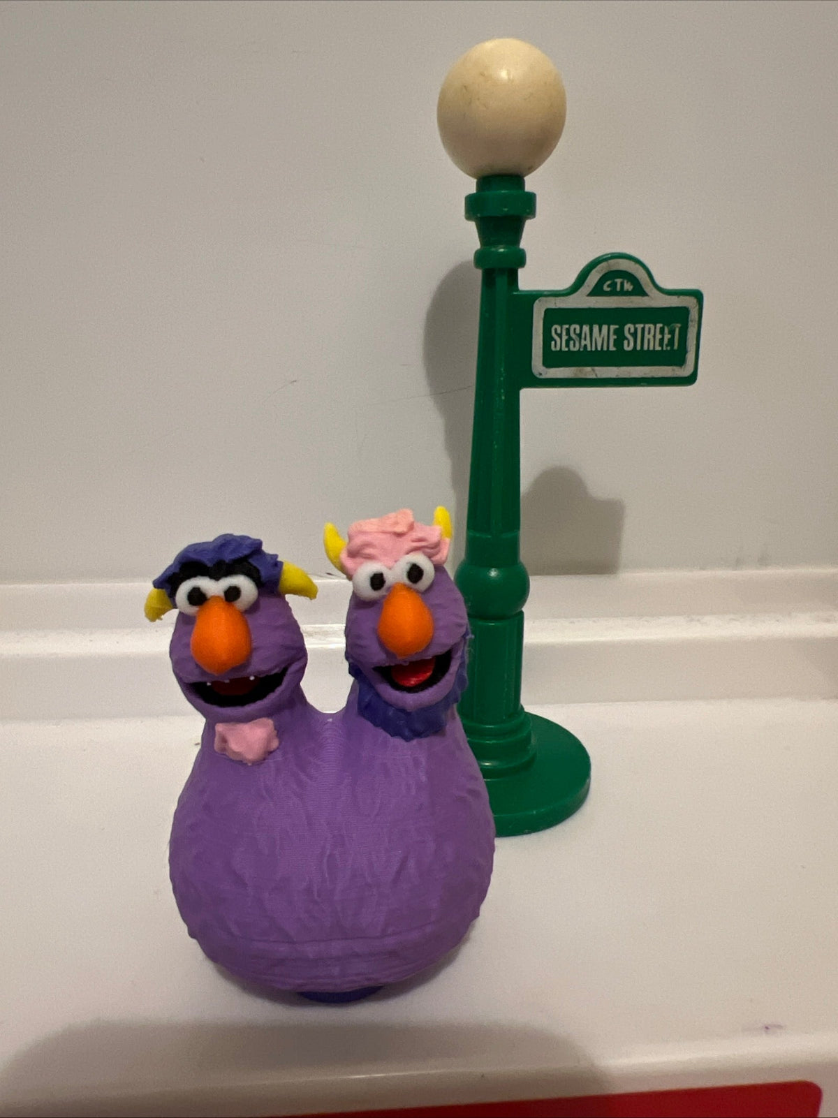 Purple two-headed monster fan-art figure on green display stand
