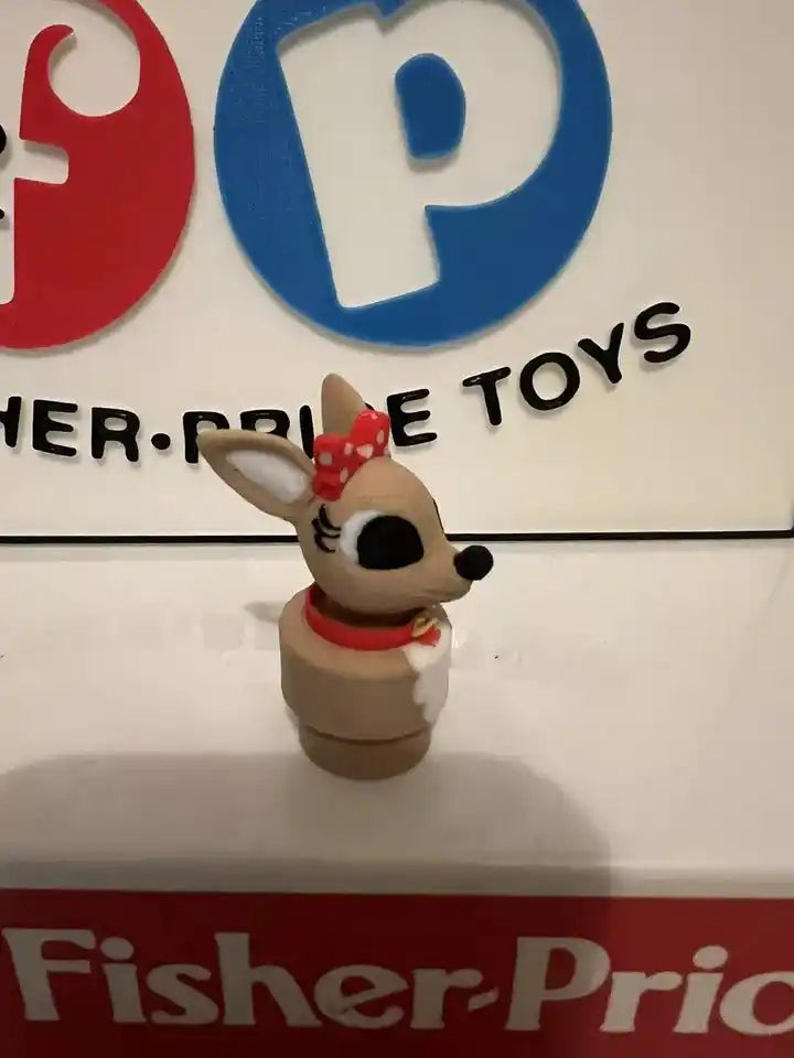 Small animal holiday figurine with red scarf and polka-dot bow, turned slightly right.