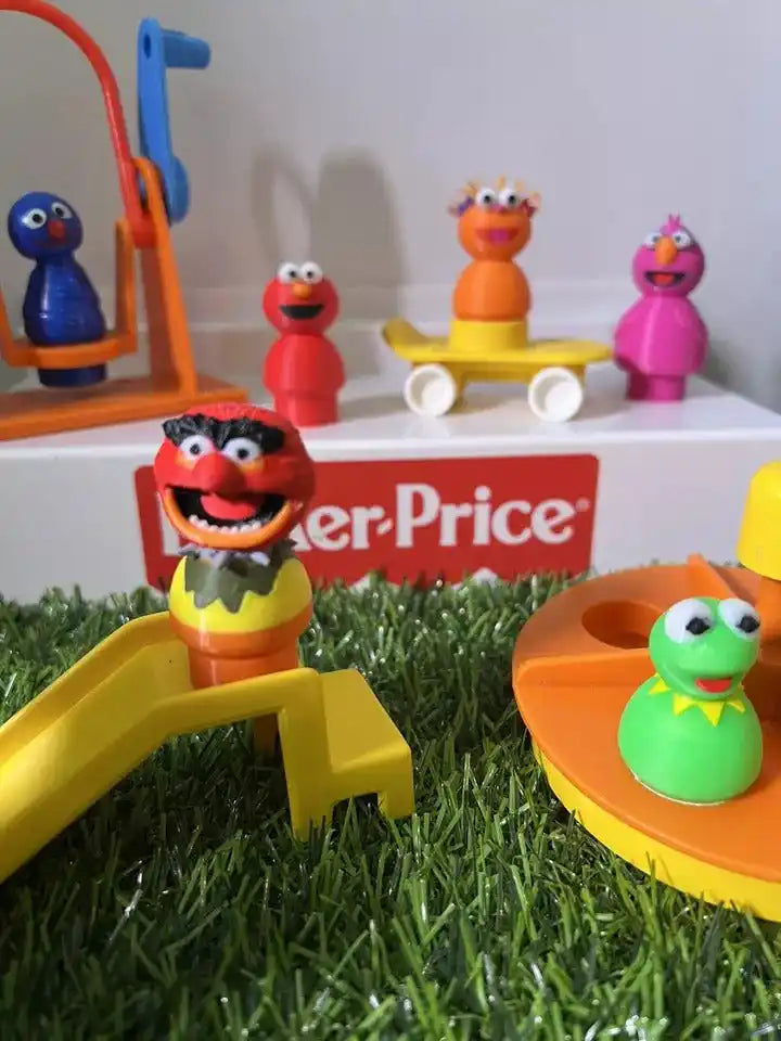 Pink bird-like custom figure on grass, with other small Fisher-Price scale toys