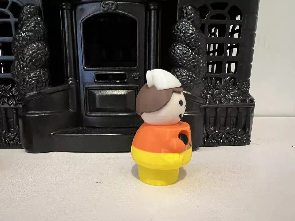 Candy corn girl figurine front view with white bonnet, orange top, and yellow skirt.
