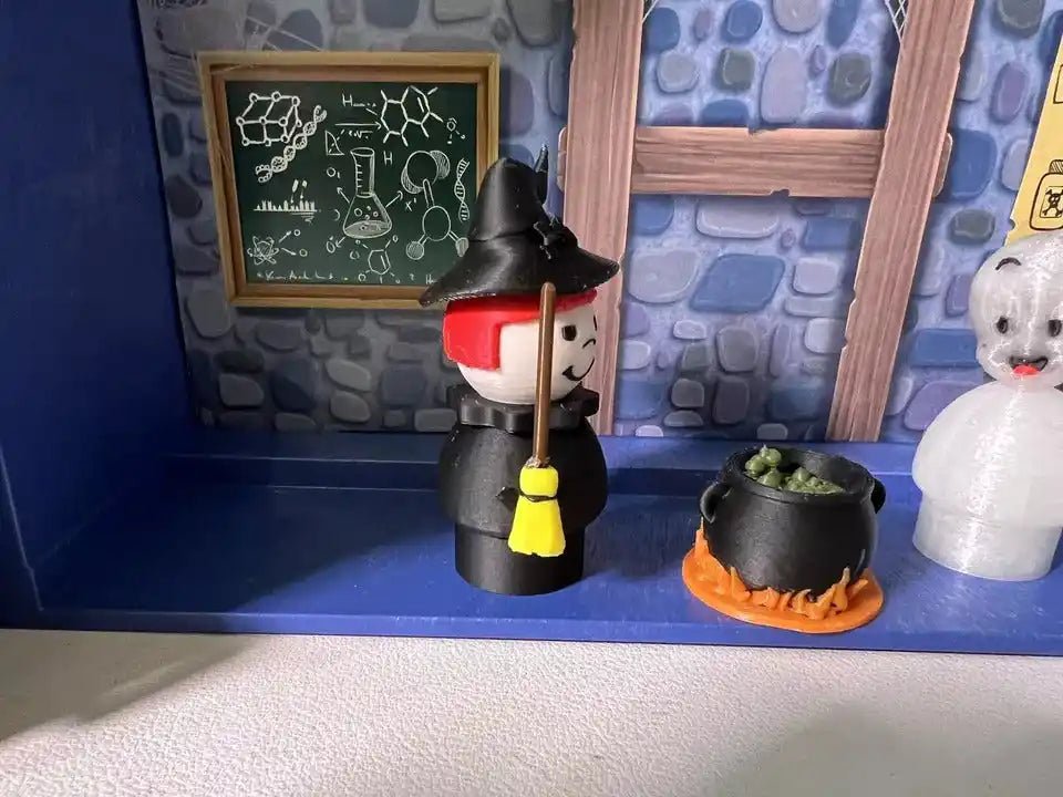 Halloween witch figurine holding broom, red collar, black stacked body