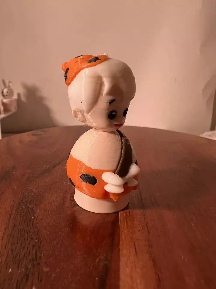 Bam Bam collectible figure in white with orange hood, holding orange club