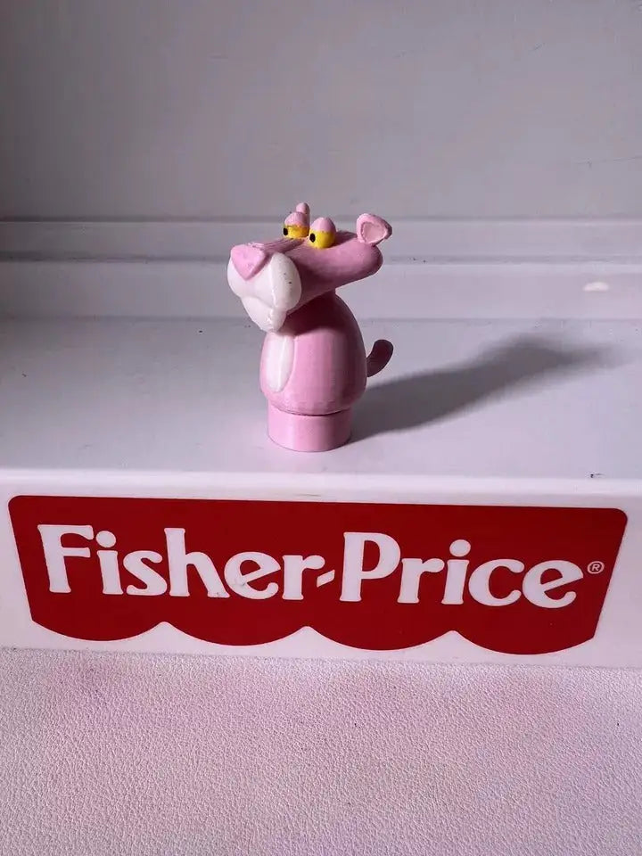 Pink panther toy figurine with yellow crown and tail, rear side view
