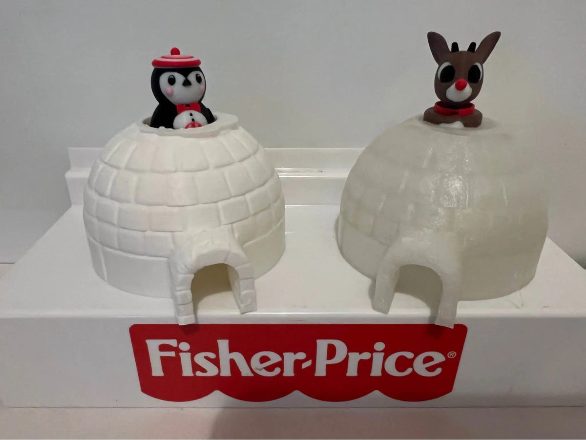 Two custom 3D-printed igloos, one snow white with a penguin figure and one transparent ice with a Rudolph figure