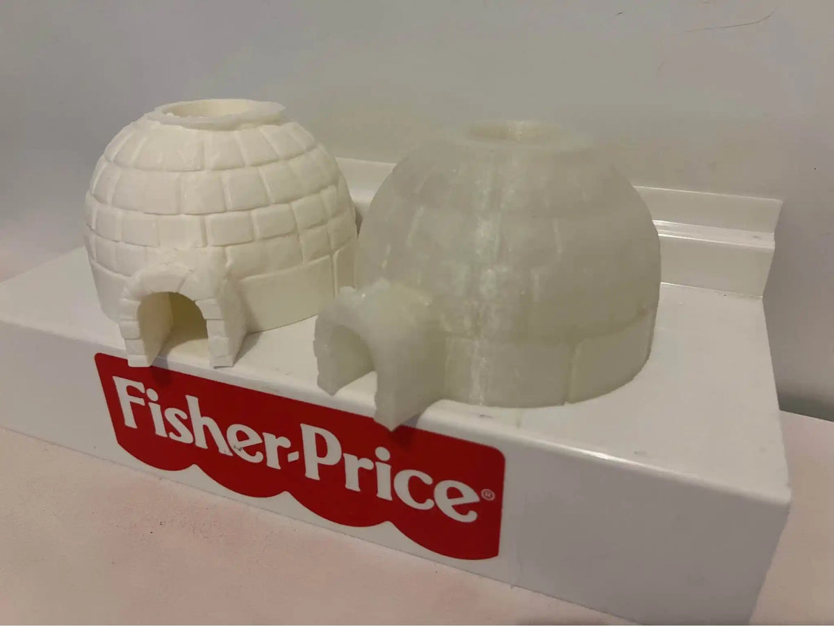 Snow white and translucent igloo-shaped holiday toys with arched doorways, angled view