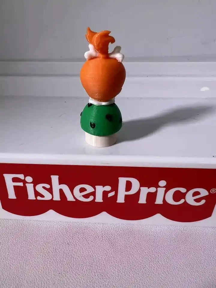 Pebbles Flintstones toy figure with orange hair top and green dress, front view