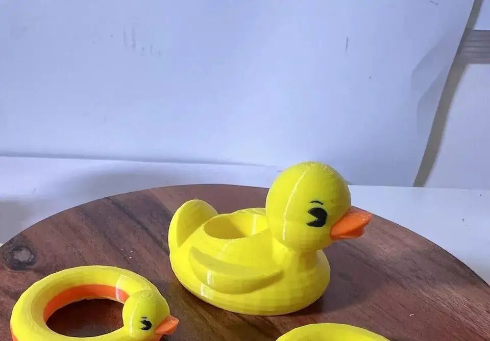 Side view of yellow duck floatie with orange beak and built-in inner ring