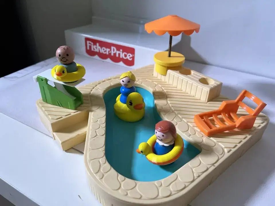 Yellow duck floatie on a blue pool base with small rider figures