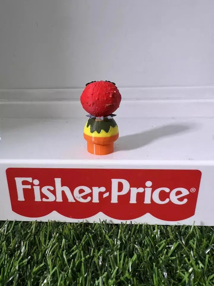 Plush animal figure with red head, yellow top, and orange base