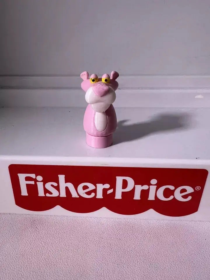 A custom 3D printed Pink Panther Little People-style figure stands on a white surface with a red Fisher-Price logo.