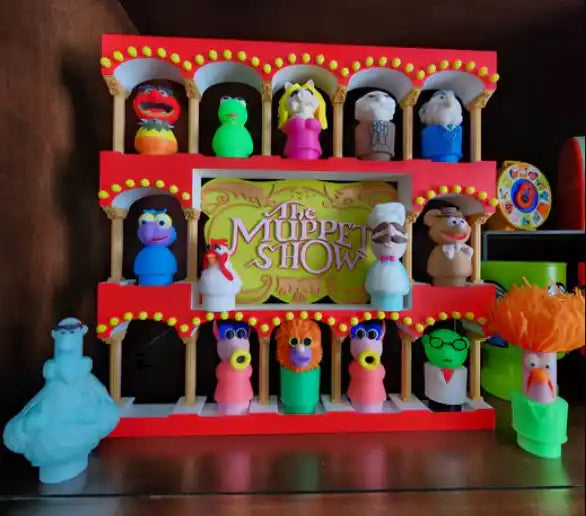 Red Muppets display stand with colorful puppet figures and 'The Muppet Show' sign