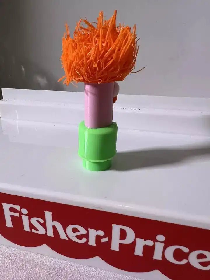 Muppets Beaker toy figure showing orange hair on a pink head and green base