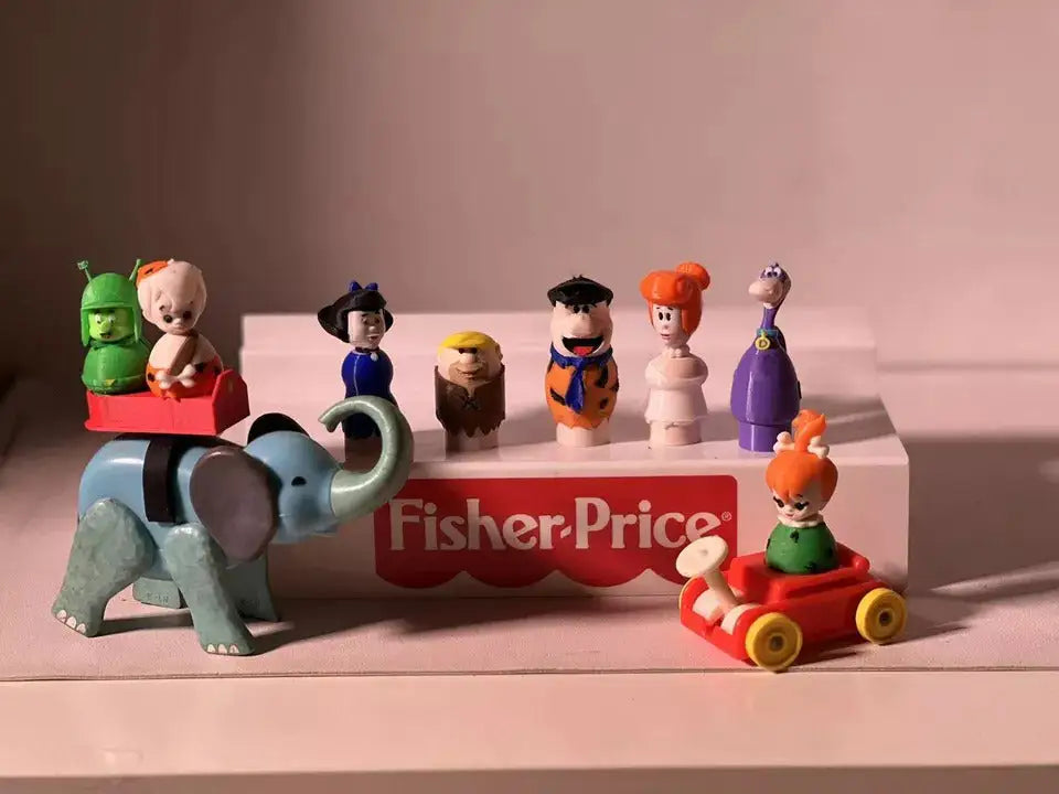 Fred Flintstone toy figure standing among other character figures