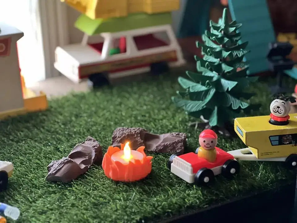 Custom Fisher-Price Little People campfire accessory lot with logs and an orange tea light fire pit in a playset scene.