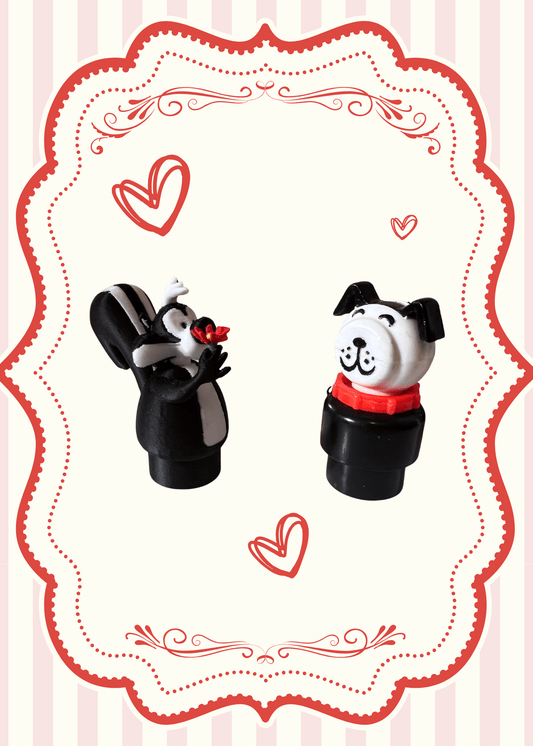 Two character toy figures: skunk with red flower, panda with red collar