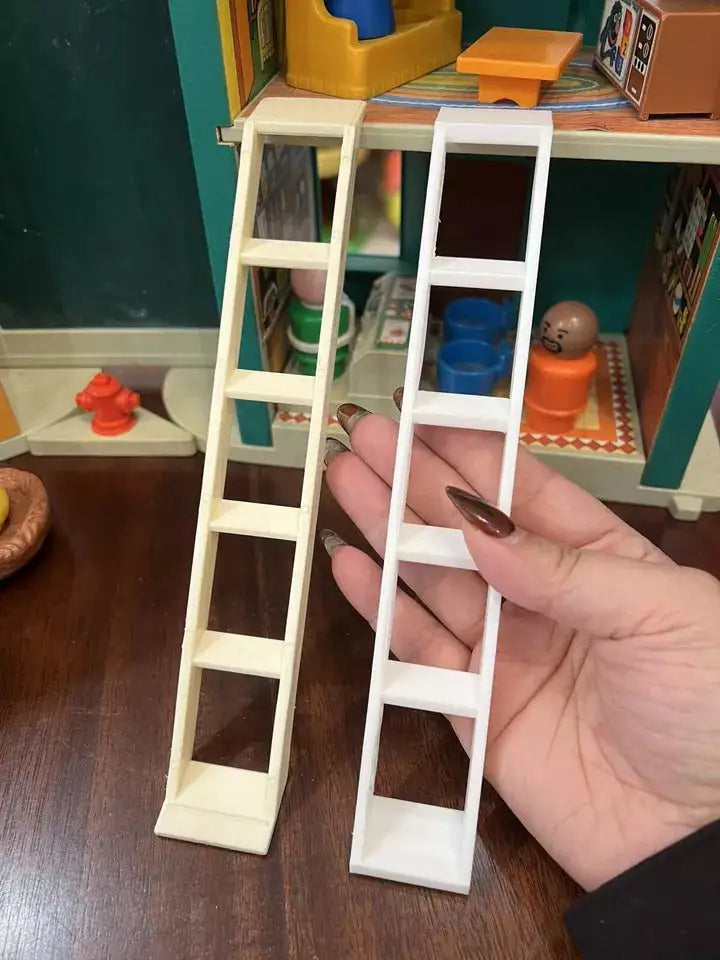 A hand holds a new white custom 3D printed replacement ladder next to a yellowed vintage Fisher Price Little People ladder.