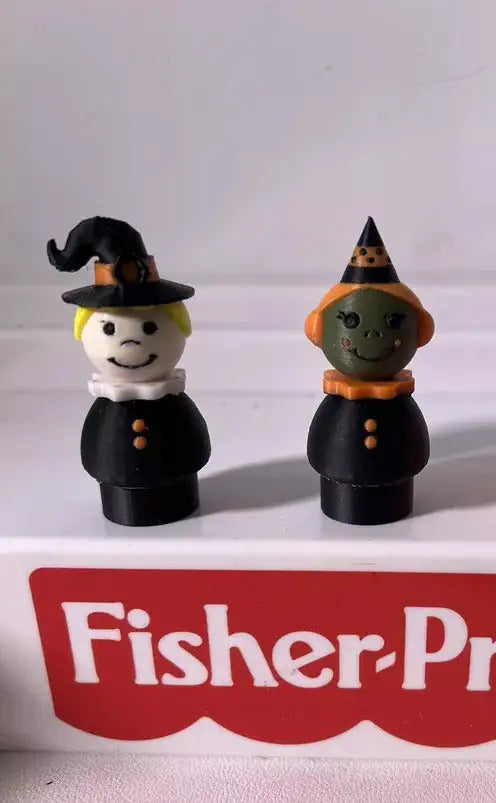 Two custom Fisher-Price Little People Halloween Spooky Witch figures, one with a white face and one with a green face