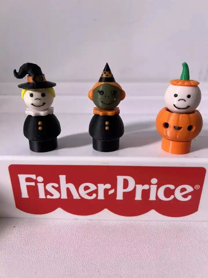 Three custom Fisher-Price Little People Halloween figures: a witch, a green-faced goblin, and a boy in a pumpkin costume.