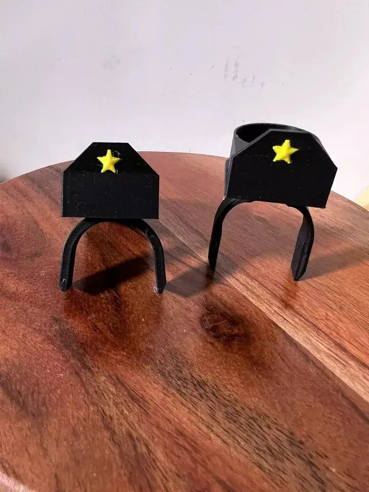 Pair of black octagonal saddle stands with yellow star details on a wooden base