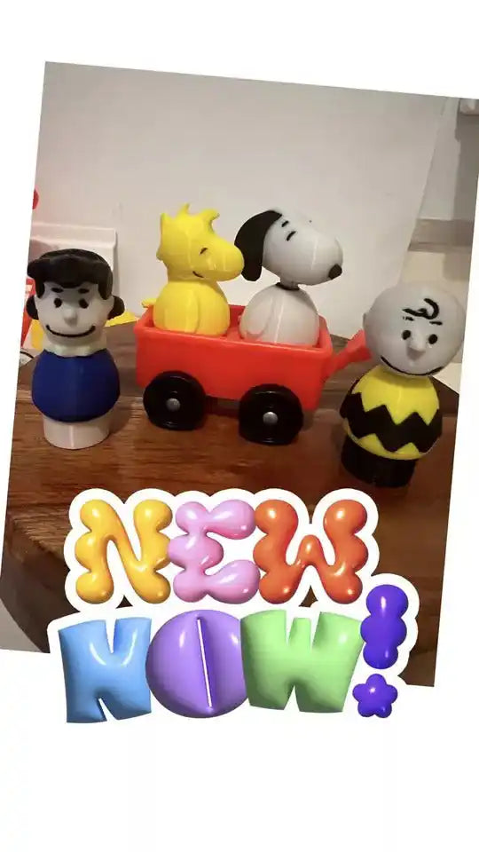 Set of four small character figures with colorful bases and block accessories