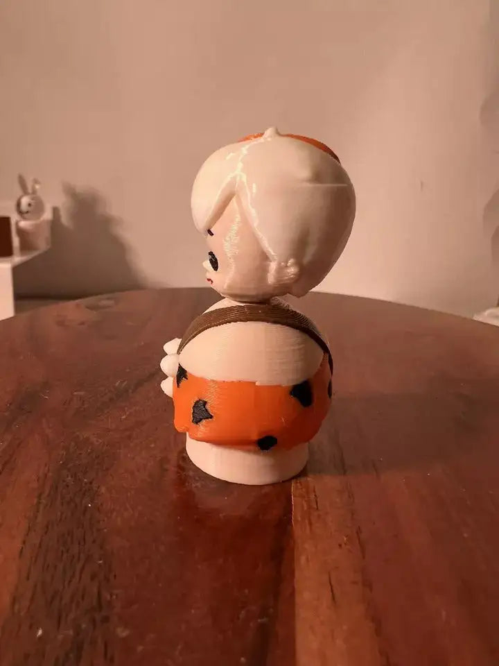 Bam Bam collectible figure side view in white with orange-and-black spots, holding club