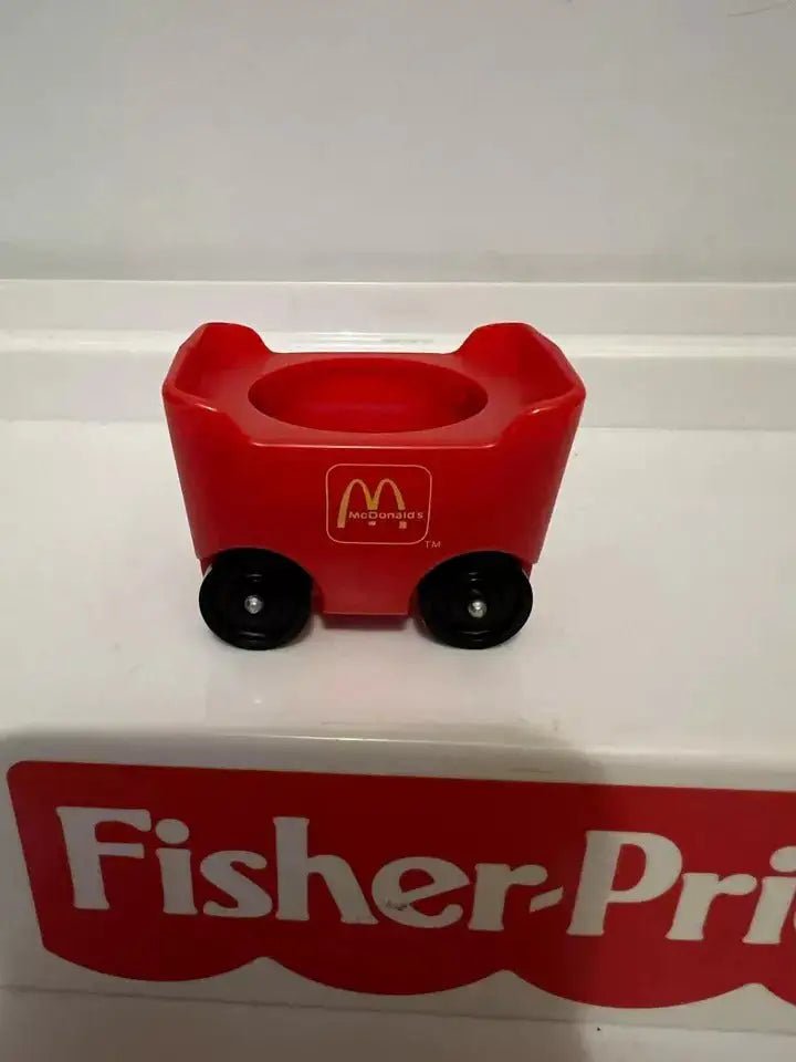 Red fry car adapter with black wheels and empty top compartment