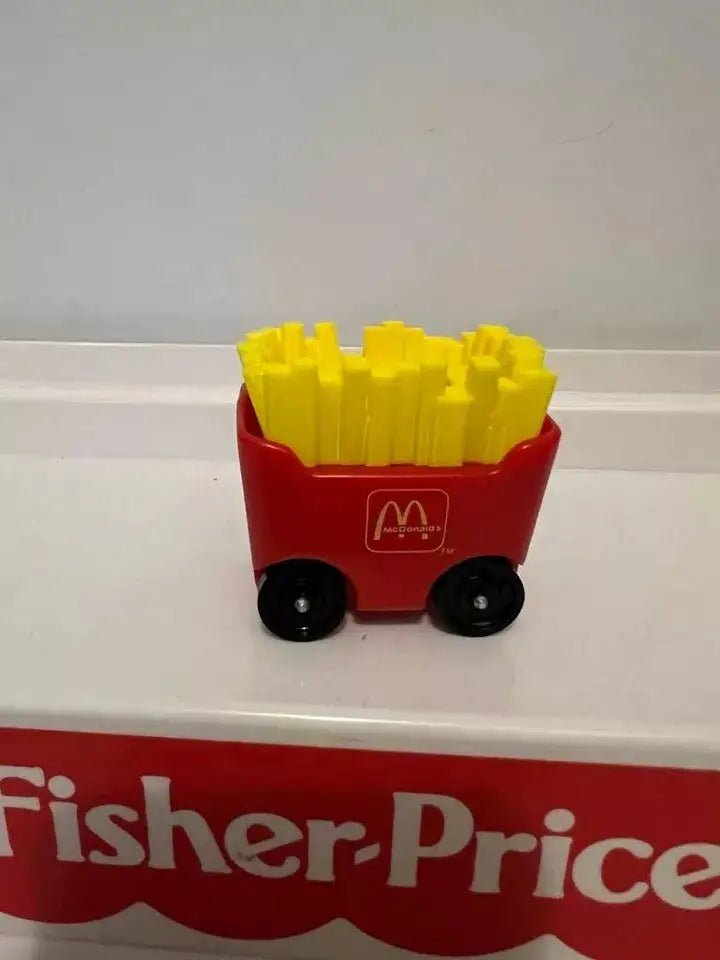 Red fry car adapter with yellow fries and black wheels on Fisher-Price platform