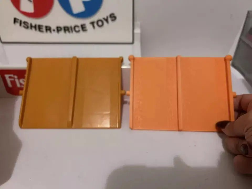 Two orange hinged plastic ramp sections with grooved panel details