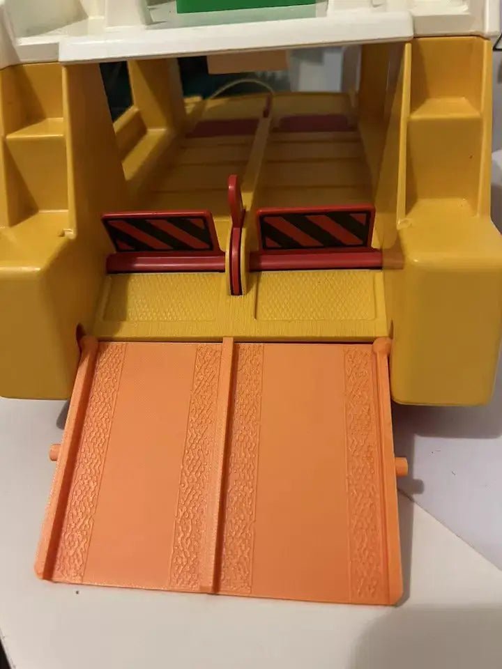 Orange textured ferry ramp with twin red-and-black striped side rails inside yellow frame