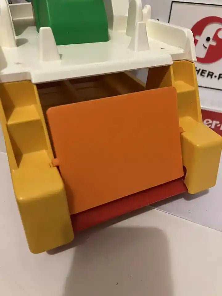 Orange plastic ramp with textured panel, mounted in yellow ferry frame with red base