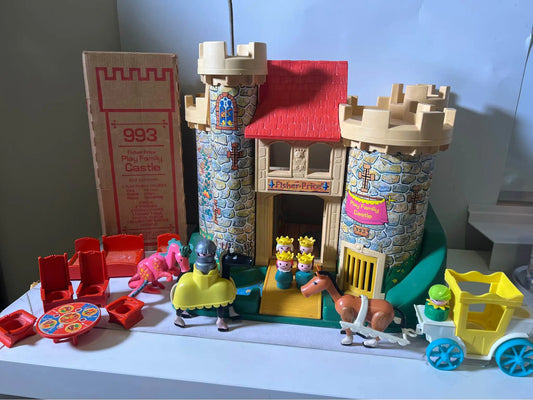 Castle playset building with red roof, blue stone walls, door, and minifigures