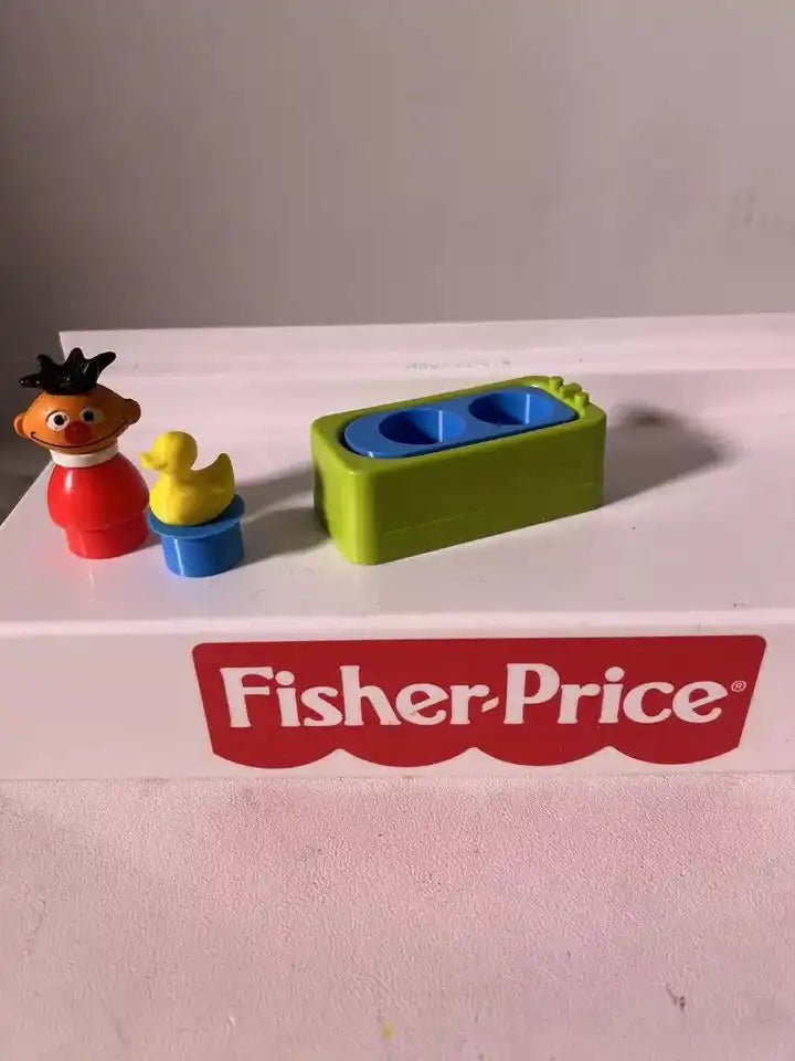 Green and blue water play insert with yellow rubber duck toy, side view