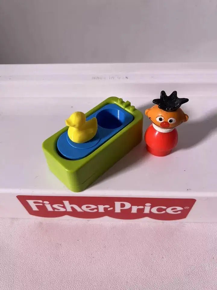 Blue and green water play insert with yellow rubber duck toy and red character